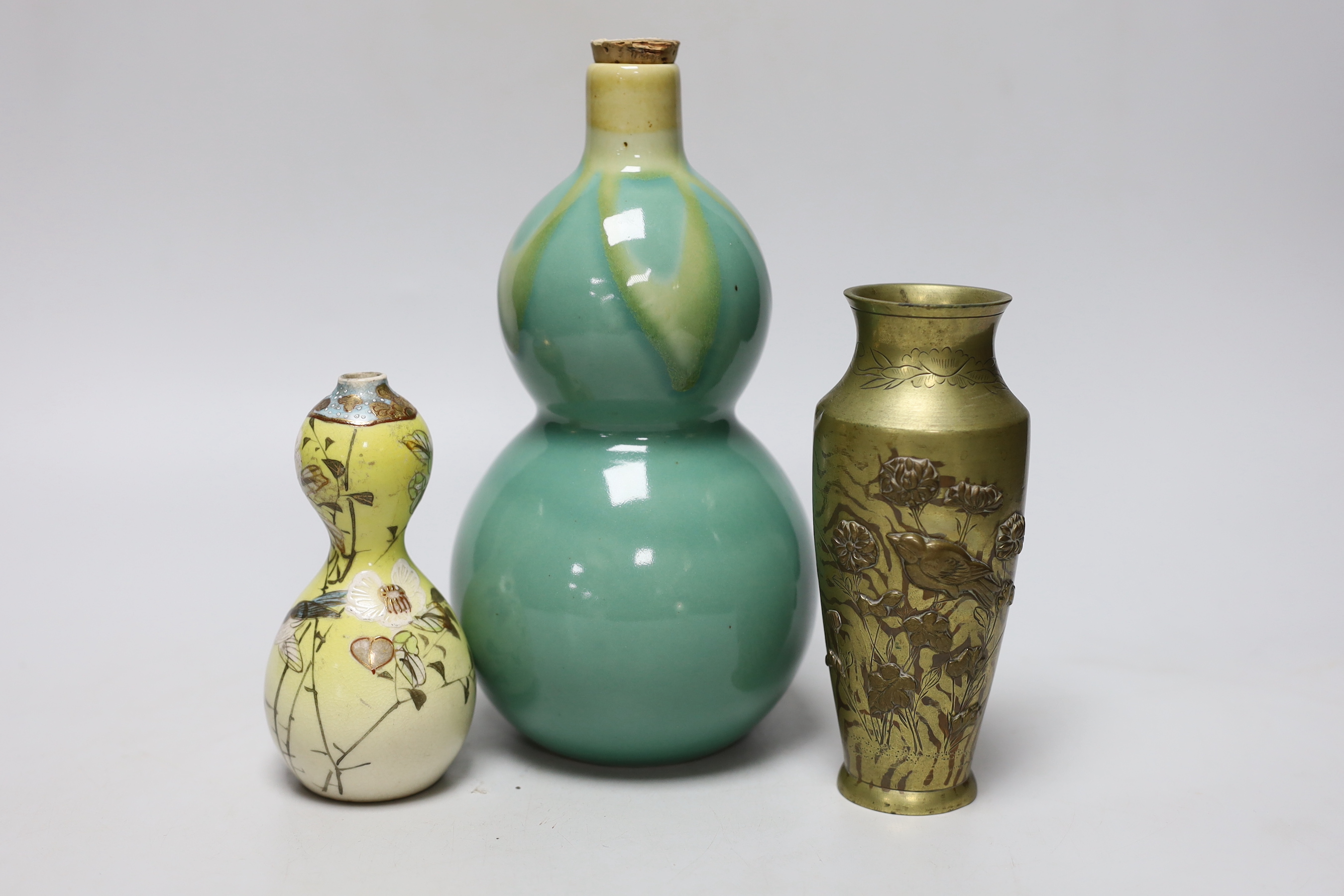 A Japanese bronze faux bois vase, a Satsuma vase and a porcelain tokkuri, a faux bois vase 15cm high (3)